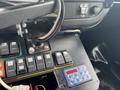 Close-up of a control panel with various switches and buttons in a 2014 Chevrolet Express vehicle