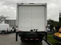 A 2020 Hino 338 truck facing forward with a large white cargo box and a lift gate at the rear