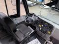 Interior view of a 2014 Freightliner B2 featuring a driver's seat and dashboard with various controls and instruments