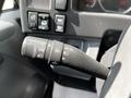 Close-up of the turn signal and cruise control lever in a 2016 Isuzu NQR truck's cabin