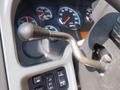 Close-up of the gear shift lever and control panel of a 2009 International 7400 showing various gauges and controls