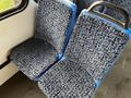 A 2017 Chevrolet Express passenger seat with a blue trim and patterned fabric upholstery