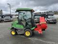 A 2014 John Deere 1585 Terrain Cut lawn mower with a cab and a red grass collection attachment on the side