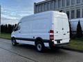 A white 2017 Mercedes-Benz Sprinter van with a high roof and rear cargo doors parked on a concrete surface