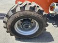 A close-up of a large tire from a 2008 JLG Boom Lift featuring rugged treads and a metallic wheel hub