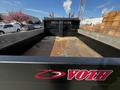 A 2021 Ford F-550 flatbed truck with wooden boards in the bed featuring a logo that reads VOTH on the side