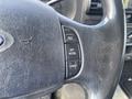 Close-up of the steering wheel control panel of a 2007 Ford F-350 SD featuring buttons for resume, set, accelerate, and coast