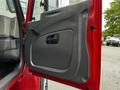 The image shows the open door of a 2011 International 4400 showing its interior handle and panel design