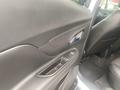 Interior view of a 2018 Buick Encore showing the driver's side door panel and armrest with controls and black upholstery