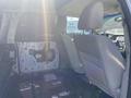 Interior view of a 2013 Ford Expedition showing the backseat area with beige upholstery and absence of door panels