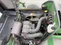 A 2009 John Deere 2653B Precision engine compartment showcasing various components including hoses a fan and electrical connections