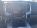 Interior dashboard of a 2021 RAM 1500 featuring a touchscreen display with climate controls and audio settings
