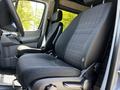 Two black cloth seats in the cabin of a 2017 Mercedes-Benz Sprinter with a focus on the driver's side seat and dashboard area