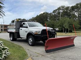 2012 Dodge Ram 5500 with a snow plow attachment in the front parked on the street