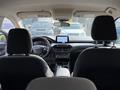 The interior of a 2020 Ford Escape featuring two front seats a dashboard with a touchscreen display and various control buttons