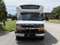 A 2017 Chevrolet Express van with a white exterior and a prominent front grille featuring a black guard and large windshield