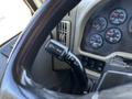 Close-up of the steering wheel and multifunction control stalk of a 2018 International DuraStar displaying controls for turn signals and wipers