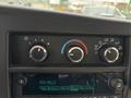Climate control knobs and radio display of a 2020 Chevrolet Express showing FM 95.3 station and various settings for air circulation and temperature adjustment