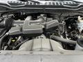 An engine seen from above in a 2017 Ford F-250 with various components including an air intake and belts visible