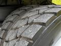 Close-up of a heavily treaded tire from a 2012 Autocar Xpert showing deep grooves and a robust design suitable for heavy-duty performance
