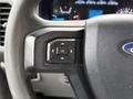 Close-up of a 2017 Ford F-350 SD steering wheel control with buttons including an "OK" option
