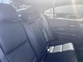 Interior of a 2017 Acura TLX showing black leather rear seats with headrests and seat belts