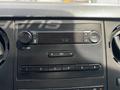 Dashboard of a 2015 Ford F-750 featuring a radio display with buttons for audio settings and volume control