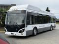 A 2018 Grande West Vicinity bus featuring a sleek, modern design with a white body and black accents, showcasing large windows and a prominently displayed company logo