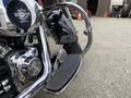 A chrome and black 2008 Harley-Davidson FLSTFI motorcycle highlighting its footpeg and engine detail