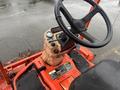 A close-up view of the dashboard and steering wheel of a 2010 Kubota F3680 featuring controls gauges and a digital display