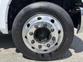 A close-up of a wheel from a 2020 Chevrolet Silverado showing a shiny chrome rim and black tire with visible tread and lug nuts