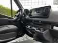 Interior view of a 2019 Mercedes-Benz Sprinter showcasing the dashboard steering wheel and console with controls and cup holders
