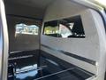 Interior view of a 2013 Lincoln MKT with plush seating and a large mirror on the rear wall