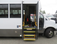 A 2020 Chevrolet Express with an open door showing a step and driver seat inside