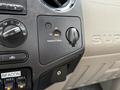 Dashboard controls of a 2008 Ford F-350 featuring a switch for passenger airbag settings and various auxiliary controls