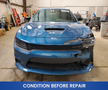 A blue 2022 Dodge Charger is shown in a damaged state with a broken front bumper and hood visible
