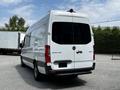 A white 2019 Mercedes-Benz Sprinter van viewed from the rear with a high roof and a large cargo area