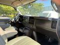 Interior view of a 2021 Chevrolet Express showing the dashboard steering wheel and front seats