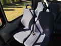 Interior seats of a 2017 Chevrolet Express with blue fabric and safety belts visible