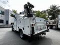 A 2016 Ford F-550 utility truck with a specialized bucket lift mounted on top and a white body featuring several compartments and storage areas