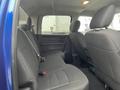 Interior view of the rear seats of a 2019 RAM 1500 Classic featuring dark cloth upholstery and seat belts