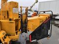 A 1993 Bandit 200 brush chipper with a yellow and black exterior featuring a large feeding chute and safety signage