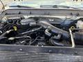 The image shows the engine compartment of a 2012 Ford F-450 SD featuring various hoses tubes and components including the air intake and cooling system
