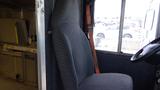 A gray fabric driver's seat in a 2011 Ford Econoline with a seatbelt visible