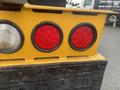 Close-up of the rear lights on a 2016 International 7400 featuring two round red lights and one smaller white light