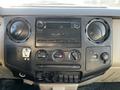 The dashboard of a 2008 Ford F-450 SD featuring the audio system climate controls and various switches for vehicle functions