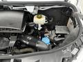 2021 Mercedes-Benz Sprinter engine compartment showing components like the air intake hose coolant reservoir and various engine parts