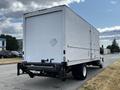 A white 2006 Hino 268 box truck viewed from the rear with a flatbed and a plain cargo area