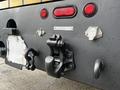 The rear of a 2008 International 7500 truck featuring red lights a towing hitch and various connectors and hooks for securing equipment