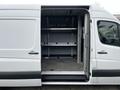 2016 Mercedes-Benz Sprinter van with an open side door revealing shelving units inside